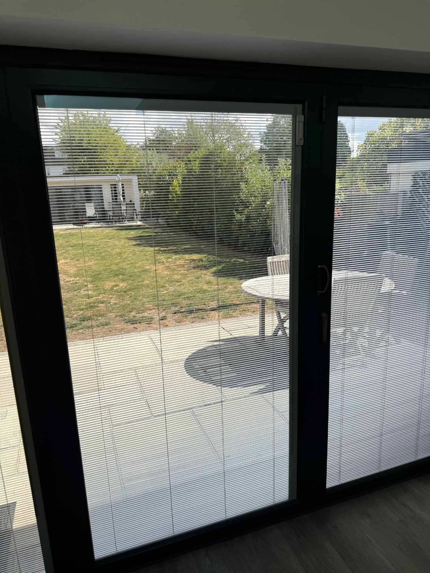 Anthracite grey sliding patio doors in an Essex home with integral venetian blinds sealed between the glass panes